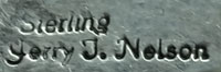 Artist signature of Jerry T. Nelson, Diné Silversmith