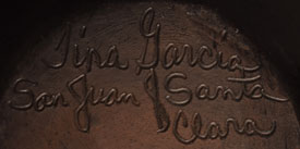 Artist signature of Tina Garcia, Santa Clara Pueblo Potter
