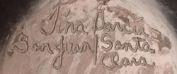 Artist signature of Tina Garcia, Santa Clara Pueblo Potter