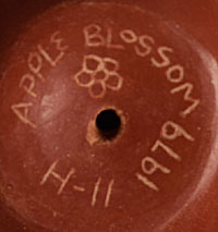 The base of the pot is signed “Apple Blossom, H-11 1979.”