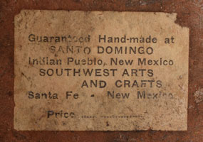 A printed paper label attached to the bowl reads as follows:  Guaranteed Handmade at SANTO DOMINGO  Indian Pueblo, New Mexico SOUTHWEST ARTS AND CRAFTS Santa Fe. New Mexico Price.......