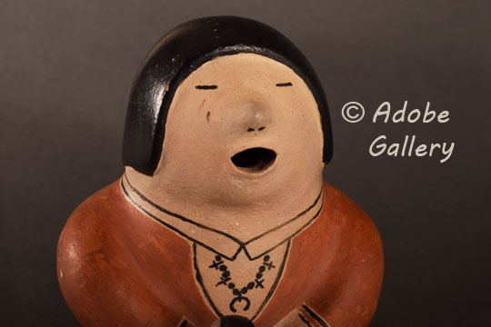 Alternate close-up view of the face of this storyteller figurine.