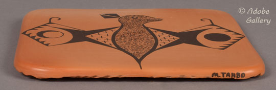 Artist signature of Hopi-Tewa Potter Mark Tahbo.  The artist signed “M. Tahbo” on the edge of the tile.