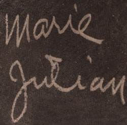 Signatures of artists Julian and Maria Martinez, San Ildefonso Pueblo artists. The bottom of the jar is signed “Marie + Julian.”