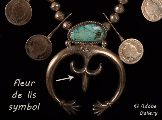 Close-up view showing the barber dimes, naja, turquoise, and fleur de lis symbol.