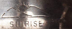 The bracelet is stamped with a hallmark that is a two-peak mountain with sunrise partially in the line between the two peaks.  Below this is the name SUNRISE.  Off to the side is STERLING. We have not yet identified to whom this hallmark belongs.