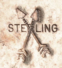 The stamped logo is a pair of crossed arrows over the word STERLING.  This logo has been mentioned as an early one of Diné silversmith John B. Begay, Jr., however, I have found no published information to substantiate this.
