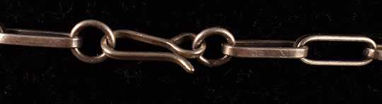 A simple hook and loop design secures this necklace.