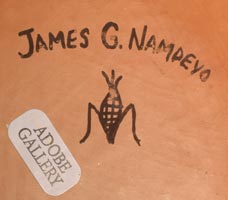 Artist signs James G. Nampeyo with his ear of corn hallmark insignia on the bottom. He was a member of the Corn Clan at Hopi Pueblo and he usually signed his name and included his hallmark corn clan symbol. 