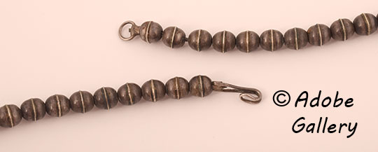 A simple hook and loop design secures this necklace. A simple hook and loop design secures this necklace.