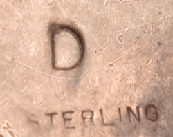 Underneath, the ring is stamped with the letter D and sterling. The maker remains unknown.