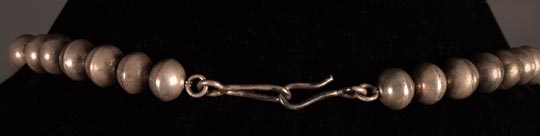 A simple hook and loop secures this necklace.