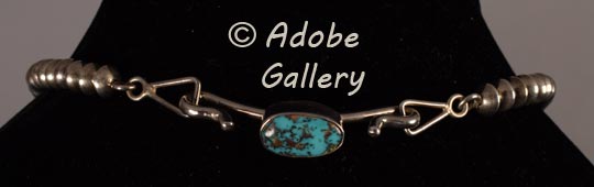 A chain extender of silver with a beautiful blue turquoise gemstone is an added feature