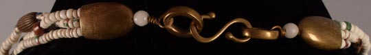 A simple hook and loop system secures this necklace.