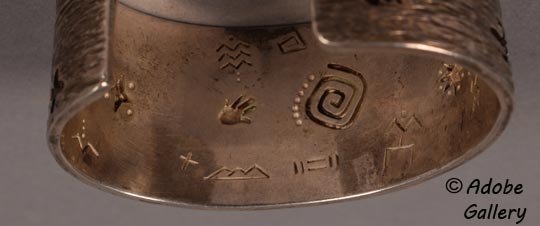 A nice surprise is found on the underside of the bracelet: there are numerous other little designs. Hands and sun images are featured again, as well as new motifs like stars, stick figures, kites, and mountains. The underside features a smooth finish.