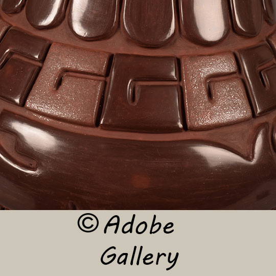 Close up view of a section of this pottery vessel.