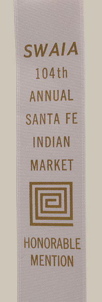 The 2026 Santa Fe Indian Market (SWAIA) award: The included ribbon confirms this jar received an Honorable Mention at the 104th Annual Santa Fe Indian Market, a testament to its artistic merit and technical execution. 