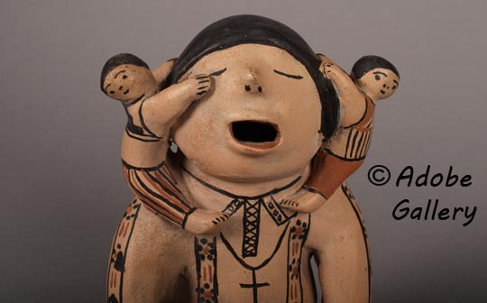 Alternate close up view of the face of this storyteller figurine.