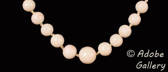 The center bead in this necklace is the single largest one. Branching out from it, each bead reduces in size with the smallest ones at the ends near the clasp.