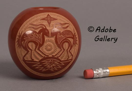 Alternate view showing the miniature scale of this pottery vessel.