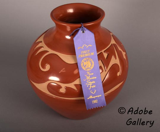 This beautifully fired red jar made by Richard Ebelacker was awarded First Premium at the 1982 New Mexico State Fair. The blue ribbon accompanies the jar. 