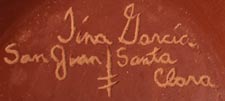 Artist signature of Tina Garcia, Santa Clara Pueblo Potter