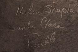 Artist signature of Helen Shupla, Santa Clara Pueblo Potter