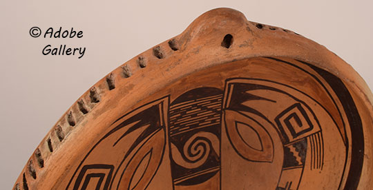 Close up view of a section of this pottery vessel.