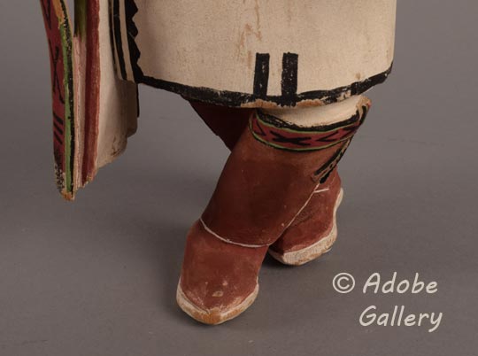 Close up of the crossed legs of this carving.