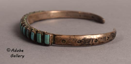 Alternate side view of this bracelet showing the designs.