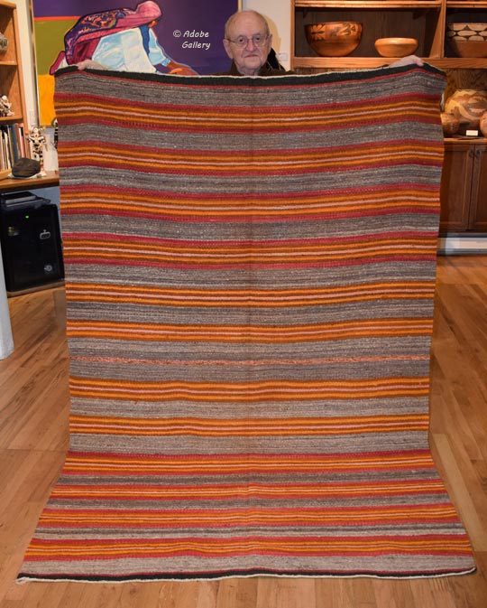AL is holding this textile.