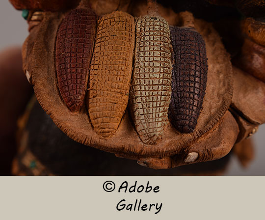 Close up view of a section of this Katsina Doll carving showing corn. Close up view of a section of this Katsina Doll carving showing corn.