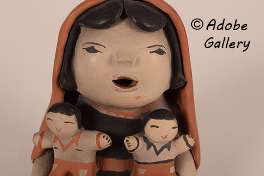 Close up view of the face of this figurine.