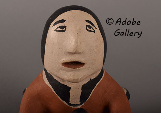 Close up view of the face of this figurine. Close up view of the face of this figurine.