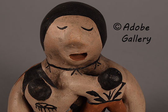 Close up view of the face of this figurine.