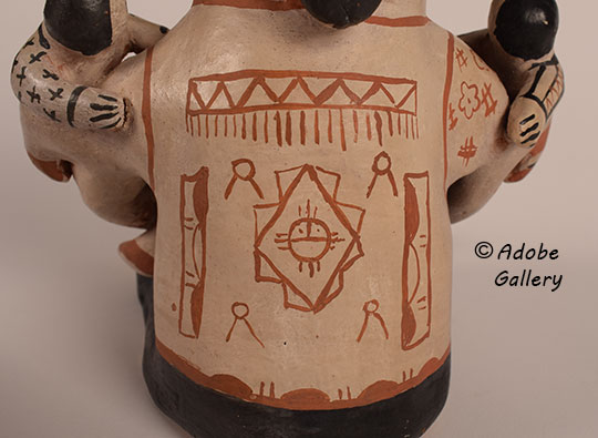 Close up view of the design on the back of the figurine. Close up view of the design on the back of the figurine.
