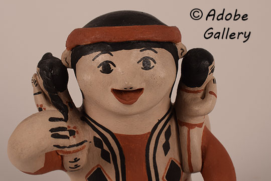Close up view of the face of this figurine.