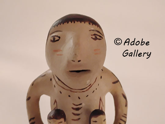 Close up view of the face of this figurine.