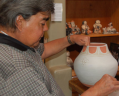 Photos right of Robert Tenorio painting one of his pottery creations are by ©Adobe Gallery.  